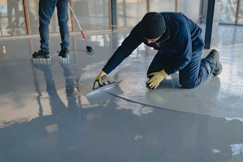 Guy swirling epoxy floor non-slip